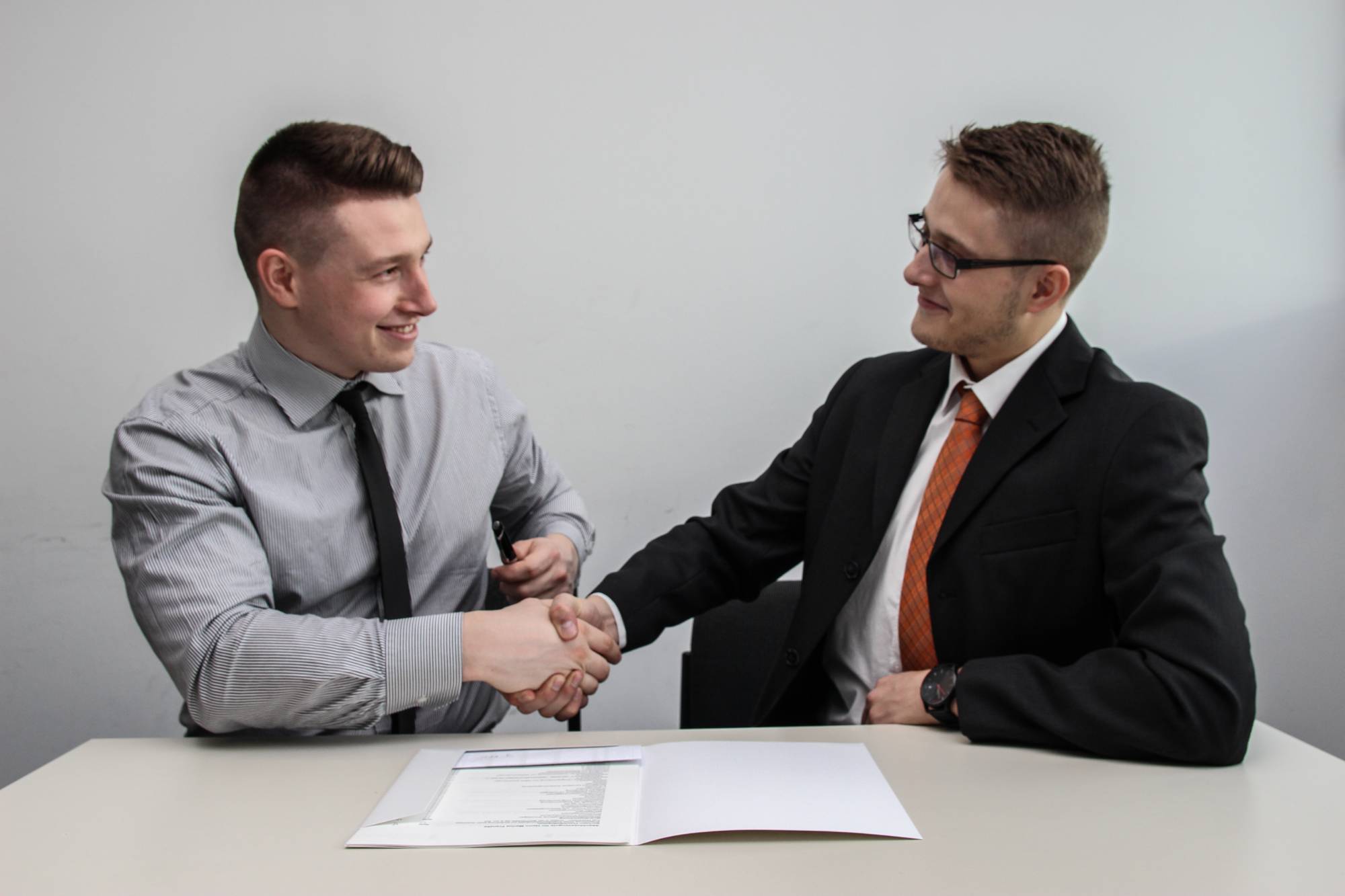 Picture of two men shaking hands to show infographic videos help boost credibility