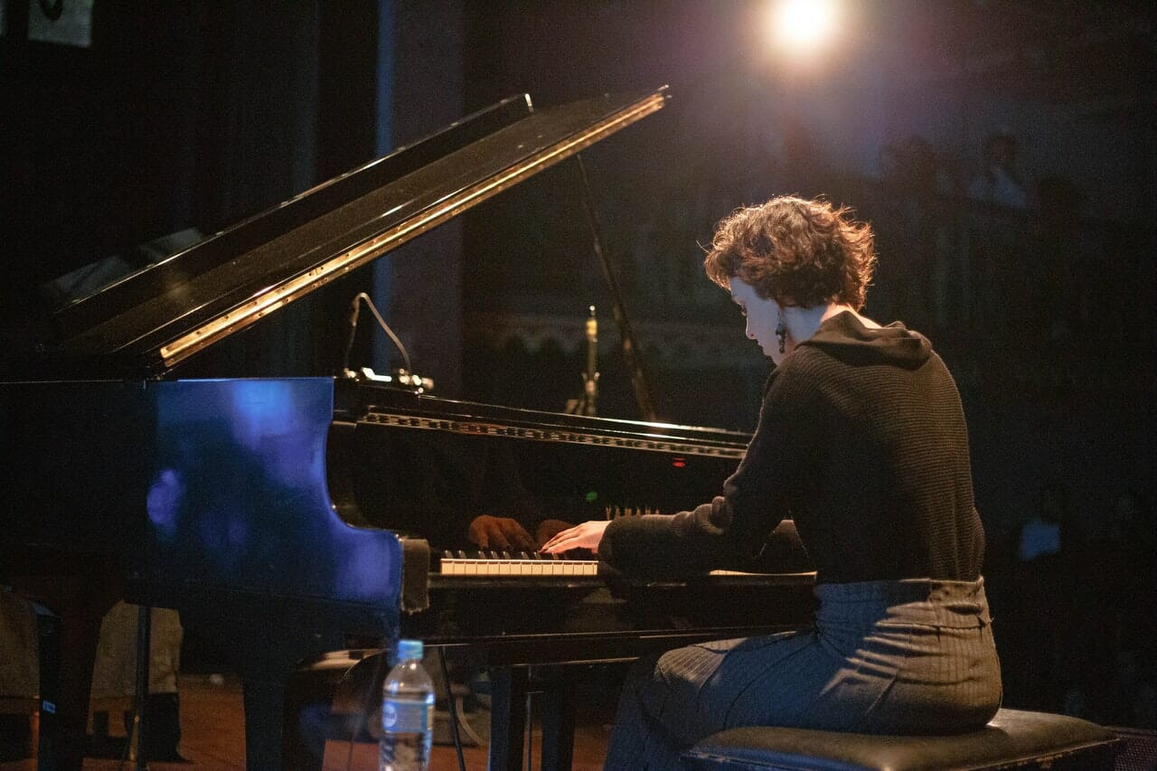 a woman playing piano during a live event video production