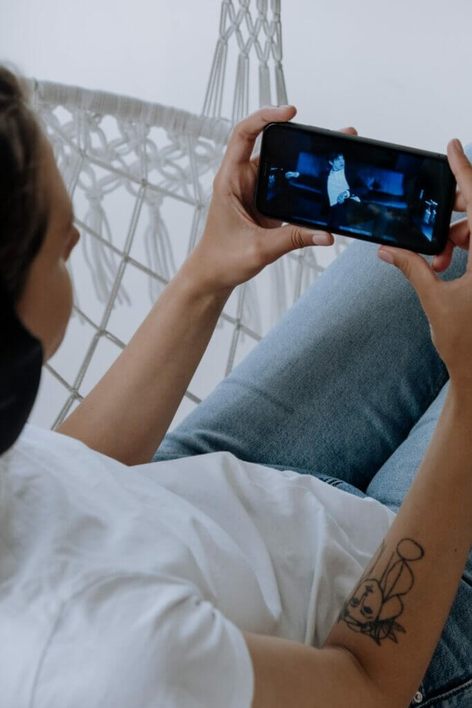 A Person Watching a Video Through Phone